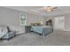 A serene main bedroom featuring plush carpeting, large windows with outdoor views, and neutral decor at 2432 Spindle Ct, Raleigh, NC 27603