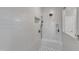 Modern walk-in shower features white subway tiles, a built-in bench, and dual shower heads at 2432 Spindle Ct, Raleigh, NC 27603