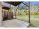 Concrete back patio shows AC unit, wood supports, lawn, and surrounding trees at 2604 Wyntercrest Ln, Durham, NC 27713