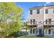 Townhome backyard features a tiered deck, an AC unit, and a treed area with stream at 2604 Wyntercrest Ln, Durham, NC 27713