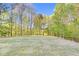 Large, treed backyard space with a manicured lawn at 2604 Wyntercrest Ln, Durham, NC 27713