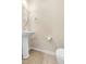 Cozy half bath with pedestal sink, round mirror and tile flooring at 2604 Wyntercrest Ln, Durham, NC 27713