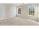 Bright bedroom featuring two windows and neutral carpet at 2604 Wyntercrest Ln, Durham, NC 27713
