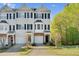 Charming townhome with blue shutters, well-manicured lawn, and a one car garage at 2604 Wyntercrest Ln, Durham, NC 27713