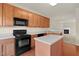 Kitchen features wood cabinets and a view into the living room at 2604 Wyntercrest Ln, Durham, NC 27713