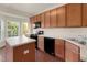 Bright kitchen features wood cabinets, an island and black appliances at 2604 Wyntercrest Ln, Durham, NC 27713