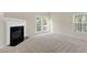 Living room features a fireplace and access to a patio via french doors at 2604 Wyntercrest Ln, Durham, NC 27713