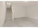 Cozy carpeted living space with a staircase leading upstairs and ample natural light at 2604 Wyntercrest Ln, Durham, NC 27713