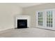Living room with a fireplace and access to the deck through french doors at 2604 Wyntercrest Ln, Durham, NC 27713