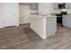 Spacious kitchen island, gray cabinets, granite countertops, and hardwood floors at 270 Palm Dr, Sanford, NC 27330