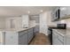 Modern kitchen with stainless steel appliances, granite countertops, and a center island with a sink at 270 Palm Dr, Sanford, NC 27330