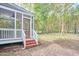Backyard view featuring screened in porch, wood stairs and lush landscaping at 2814 Sarah Ave, Durham, NC 27707