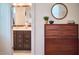 Bathroom view featuring a double vanity with a mirror and a glimpse of a well-lit bedroom beyond at 2814 Sarah Ave, Durham, NC 27707