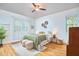 Cozy bedroom featuring a queen-sized bed, a ceiling fan, hardwood floors, and a serene ambiance at 2814 Sarah Ave, Durham, NC 27707