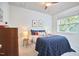 Comfortable bedroom with a cozy bed, bright lighting, and a view of the lush greenery outside at 2814 Sarah Ave, Durham, NC 27707