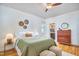 Comfortable bedroom with green bedding, hardwood floors, a ceiling fan, and an ensuite bathroom at 2814 Sarah Ave, Durham, NC 27707