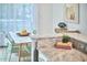 Bright dining area with a white table, green chairs, and natural light from large windows at 2814 Sarah Ave, Durham, NC 27707
