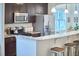 Kitchen detail showcasing stainless steel appliances and a marble countertop bar at 2814 Sarah Ave, Durham, NC 27707