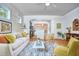 Bright living room with white walls, modern furnishings, and an open layout leading to the kitchen at 2814 Sarah Ave, Durham, NC 27707