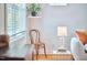 Cozy living room detail featuring a chair near a sunny window with a lamp on a side table at 2814 Sarah Ave, Durham, NC 27707
