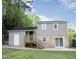 Two-story home features a deck, sliding glass door, gray siding, and a brick facade on the lower half of the rear elevation at 2824 Wyncote Drive, Raleigh, NC 27603