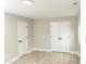 Basement room with fresh paint, updated flooring, modern lighting, and a closet offering ample storage space at 2824 Wyncote Drive, Raleigh, NC 27603