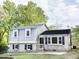 Charming home featuring brick and light gray siding, black shutters, and a well-maintained front yard at 2824 Wyncote Drive, Raleigh, NC 27603