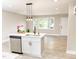 Kitchen island with seating, stainless steel dishwasher, stylish faucet, and modern pendant lighting at 2824 Wyncote Drive, Raleigh, NC 27603