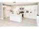Modern kitchen featuring white cabinets, stainless steel appliances, island with sink, and stylish pendant lighting at 2824 Wyncote Drive, Raleigh, NC 27603