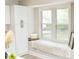 Kitchen features white cabinets, stainless steel appliances, and a cozy window seat with view of the outside at 2824 Wyncote Drive, Raleigh, NC 27603