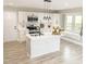 Modern kitchen featuring white cabinets, stainless steel appliances, island with sink, and a cozy window seat at 2824 Wyncote Drive, Raleigh, NC 27603
