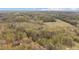 Scenic aerial view of expansive wooded acreage, showcasing a private homesite and surrounding landscape at 2931 Western Hills Ln, Elon, NC 27244
