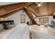 Bright, open bedroom with wood floors, beamed ceilings, and serene views from multiple windows at 2931 Western Hills Ln, Elon, NC 27244