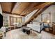 Cozy bedroom under exposed beams, featuring a daybed, desk, and natural light at 2931 Western Hills Ln, Elon, NC 27244