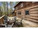 Exterior shot of a wrap-around deck featuring a seating area with a view of the backyard and woods at 2931 Western Hills Ln, Elon, NC 27244