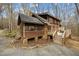 Charming log home with a screened porch and deck, nestled on a wooded lot with mature trees at 2931 Western Hills Ln, Elon, NC 27244