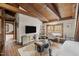 Living area with exposed beams, large TV, and cozy seating; perfect for relaxation at 2931 Western Hills Ln, Elon, NC 27244