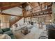 Open-concept living area with high ceilings, wood beams, and seamless flow to the kitchen at 2931 Western Hills Ln, Elon, NC 27244