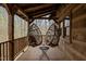 Cozy porch with two hanging chairs, providing a tranquil and inviting outdoor seating area with a wooded view at 2931 Western Hills Ln, Elon, NC 27244