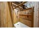 Rustic outdoor shower enclosed with wood panels and featuring a shower head and built-in shelves at 2931 Western Hills Ln, Elon, NC 27244