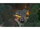 Aerial view of a luxurious home surrounded by lush greenery, a circular driveway, and a well-manicured lawn at 3016 Allansford Ln, Raleigh, NC 27613