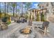 Spacious backyard featuring a stone fire pit, comfortable seating, and manicured landscaping at 3016 Allansford Ln, Raleigh, NC 27613