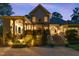 Stunning backyard with a tranquil fountain, lush greenery, a covered porch and an inviting outdoor seating area at 3016 Allansford Ln, Raleigh, NC 27613