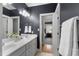 Stylish bathroom featuring double sinks, modern lighting fixtures, and a sleek dark grey color scheme at 3016 Allansford Ln, Raleigh, NC 27613