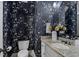 Stylish powder room featuring dark floral wallpaper, granite countertop, and decorative mirror at 3016 Allansford Ln, Raleigh, NC 27613