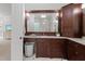 Bathroom with a dark wood vanity, granite countertop, mirror, and decorative lights at 3016 Allansford Ln, Raleigh, NC 27613