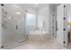 Bright bathroom features a glass enclosed shower, soaking tub, decorative window, and tile floors at 3016 Allansford Ln, Raleigh, NC 27613