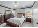 Comfortable bedroom featuring a wooden bed, dresser with mirror, and bright windows, creating a serene atmosphere at 3016 Allansford Ln, Raleigh, NC 27613