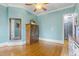Spacious bedroom featuring hardwood floors, ceiling fan, and light blue walls at 3016 Allansford Ln, Raleigh, NC 27613