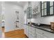 Butler's pantry features custom cabinetry, granite countertops, and a glass door leading to other living spaces at 3016 Allansford Ln, Raleigh, NC 27613